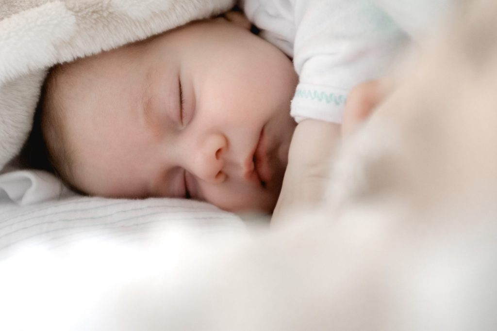 baby sleeping on a bed