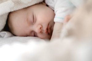 baby sleeping on a bed