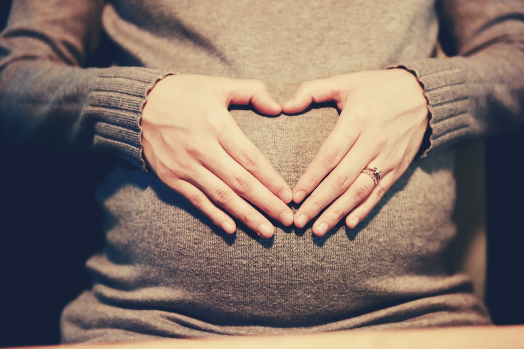 pregnant woman holding belly