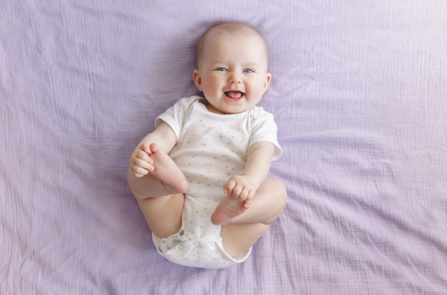 baby sleeping in bed with parents