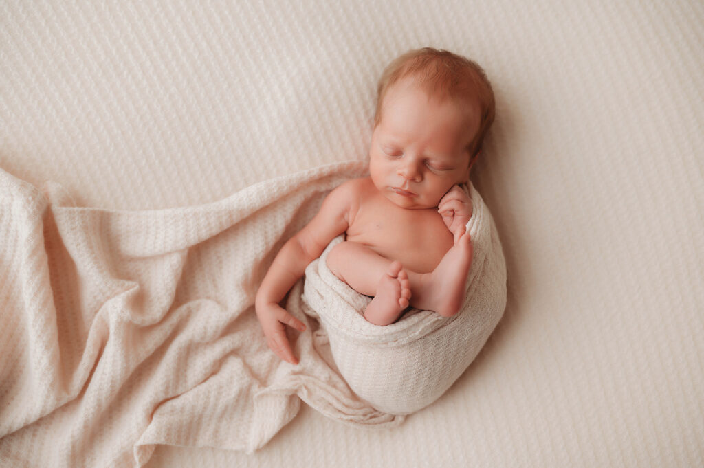 baby sleeping in bed with parents